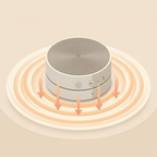 Round electronic device with spiral design on a beige background