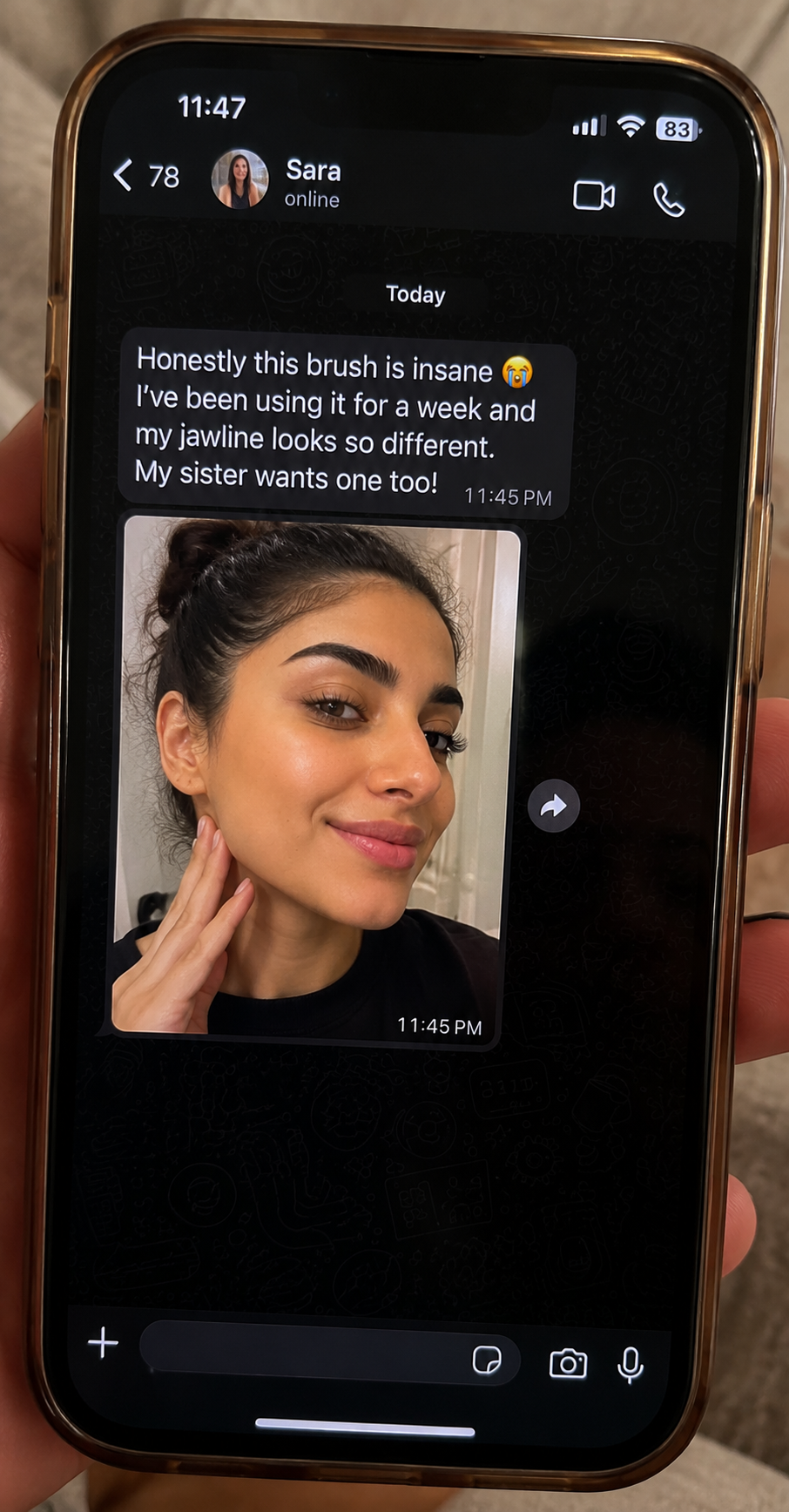Phone screen showing a text message with a photo of a woman using a product, held by a person.